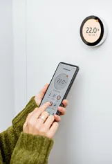 Person using thermostat