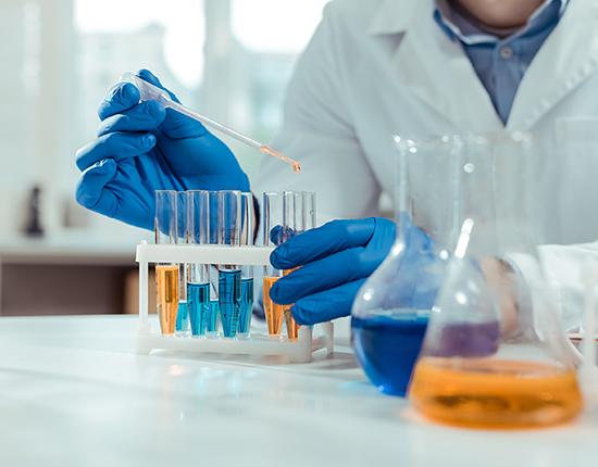 Scientist in lab with test tubes